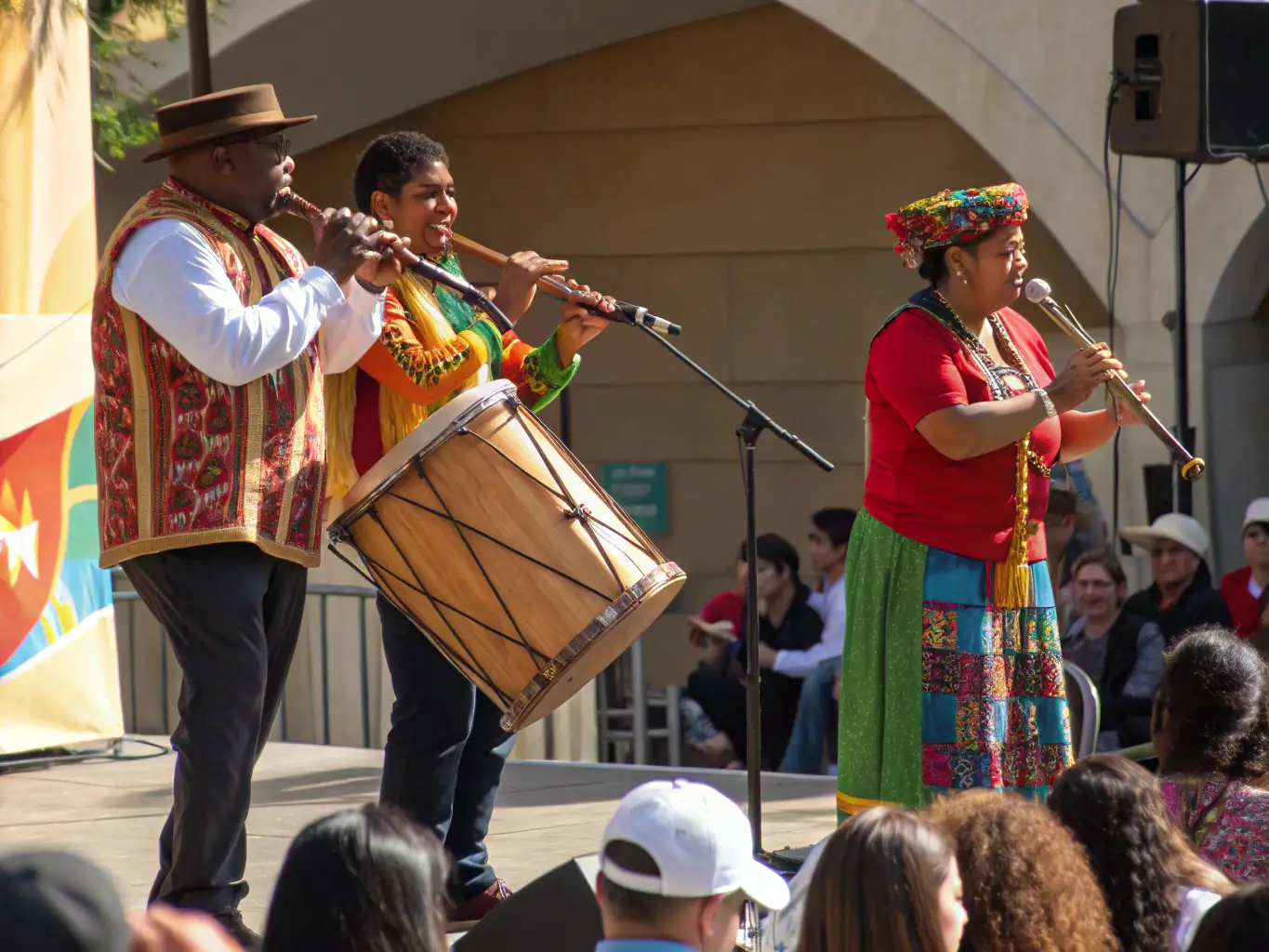 A dynamic image featuring a group of musicians playing traditional instruments from different parts of the world, highlighting the diversity and richness of world music. The setting is a concert hall or outdoor stage.