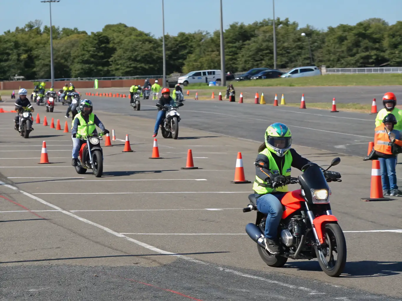 A group of motorcyclists participating in a safety training session, focusing on proper riding techniques and hazard awareness, set against a backdrop of scenic mountain roads in Alpes-de-Haute-Provence.
